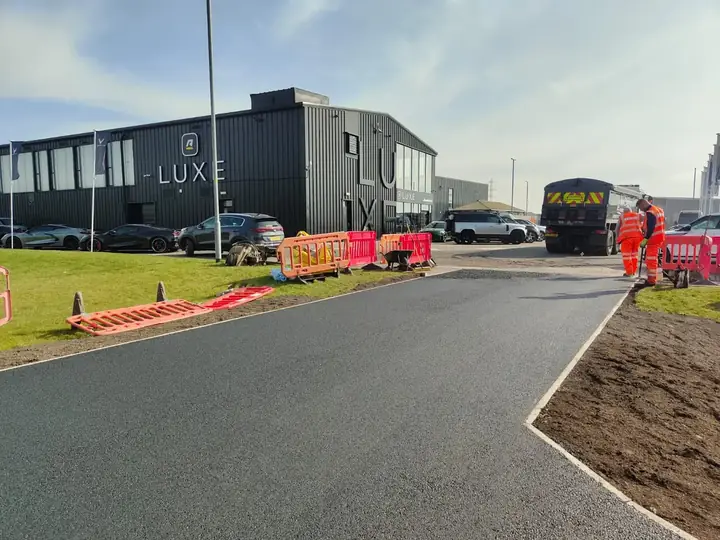 Groundworks crew excavating and preparing a sub-base for a new driveway in Scotland